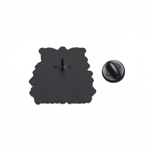 Macro view of the black matte enamel pin back showing the metal needle and rubber clutch