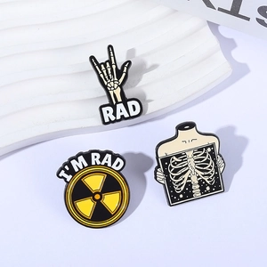 Three gothic skeleton enamel pins set with RAD skull and radiation symbols for denim jackets
