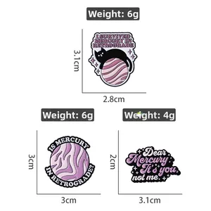 Creative purple enamel pins featuring black cat and Mercury in Retrograde space themes