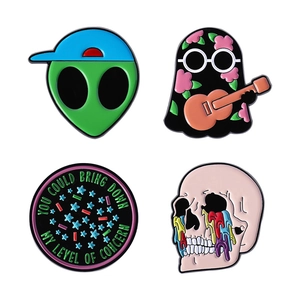 Set of four colorful 21 Pilots inspired enamel pins with alien, ghost and skull designs