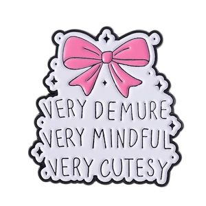 Pink bow enamel brooch pin with Very Demure Very Mindful text on white background