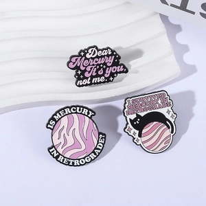 Three-piece enamel pin set featuring a planet, black cat, and funny quotes in purple and pink