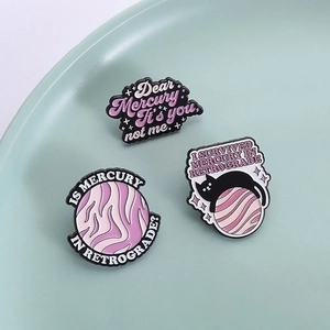 Three enamel pins featuring Mercury in Retrograde themes with planets and a black cat