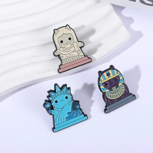 Three-piece set of cartoon cat enamel pins featuring Statue of Liberty and Pharaoh designs