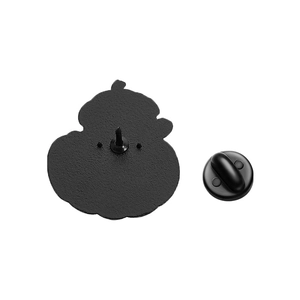 Detail view of the black metal pin back with matte texture and rubber clutch attachment
