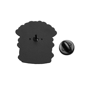 Detail of metal cat brooch back showing the black rubber pin clutch and plating texture