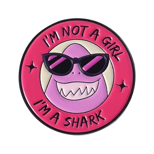 Broche ronde en émail avec motif requin violet et texte humoristique sur fond rose