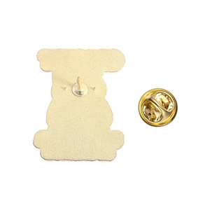 Macro view of the golden metal pin back and butterfly clasp of the cat lapel badge