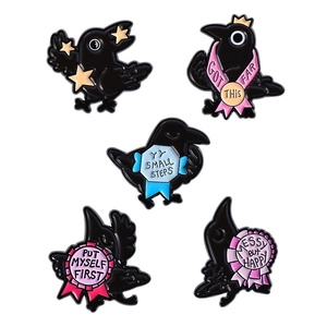 Set of 5 black raven enamel pins with inspirational quotes and gold star accents