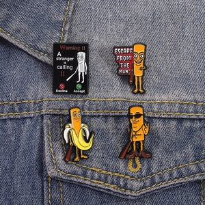 Funny cartoon banana man and telephone warning enamel pins set on blue denim background