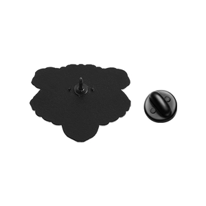 Macro detail of the matte black metal brooch back with secure black rubber clutch pin