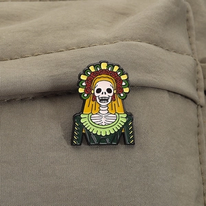 Detailed enamel pin featuring a vibrant Day of the Dead skeleton skull on canvas