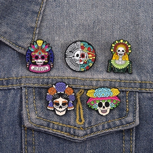 Set of 5 Day of the Dead enamel skull pins pinned on a blue denim jacket pocket