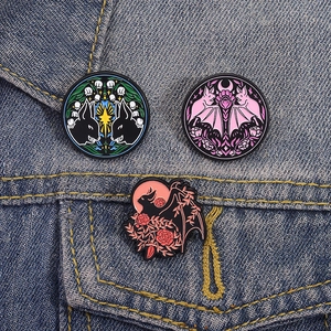 Gothic bat and rose enamel pins set displayed on a blue denim jacket pocket