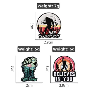Cartoon Big Foot enamel pins set featuring sunset fishing and forest landscape designs