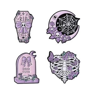 Gothic Halloween enamel pin set with skull coffin and floral ribcage motifs