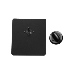 Macro detail of enamel pin back with black alloy matte texture and rubber clutch