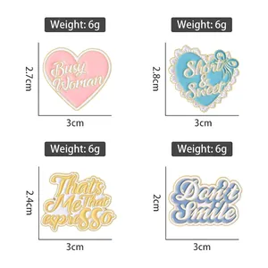 Set of four colorful heart enamel pins with stylish typography for clothing decor