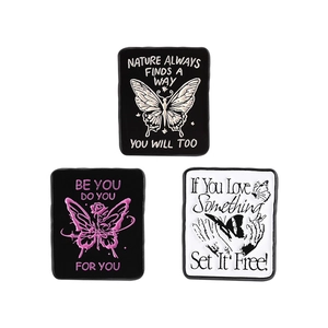 Set of butterfly enamel pins with inspirational quotes on black and white rectangle bases