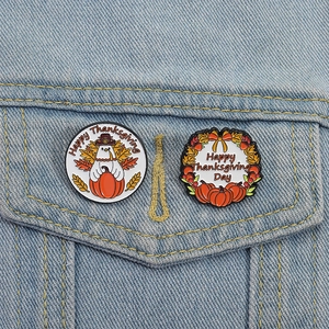 Creative Thanksgiving enamel pins with turkey and pumpkin motifs on denim jacket