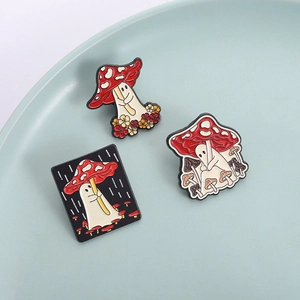 Three-piece ghost and mushroom enamel pin set featuring cartoon designs on a ceramic tray