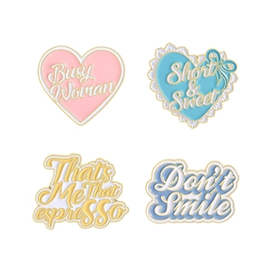 Set of four stylish enamel pins featuring heart shapes and trendy letter patterns