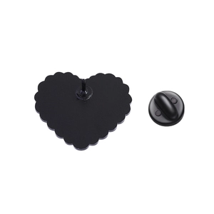 Close-up of black heart cat brooch showing textured back metal and rubber pin clutch