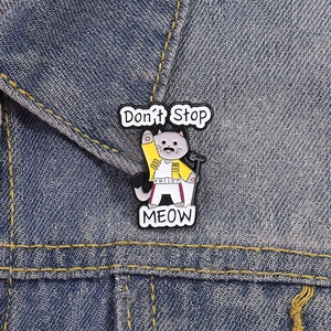 Creative Freddie Mercury cat enamel pin with Don't Stop MEOW text on denim fabric