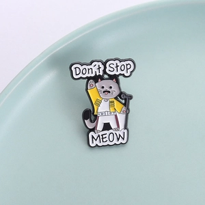 Freddie Mercury cat enamel pin with yellow jacket and Don't Stop Meow text on ceramic base