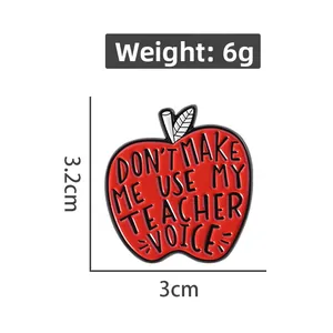 Detail of red apple enamel pin with teacher quote engraving and 3cm size measurement