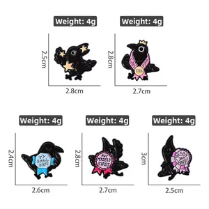 Set of five cartoon raven enamel pins with inspirational phrases and alloy finish