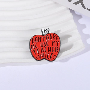 Red enamel apple brooch with Don't Make Me Use My Teacher Voice text for teachers