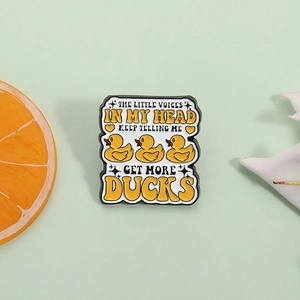 Humorous enamel pin with yellow ducks and funny quote on a fresh green background