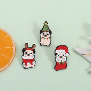 Three festive pug enamel pins with Christmas tree, reindeer antlers, and stocking designs