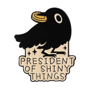 Funny crow enamel pin badge with President of Shiny Things quote in black and gold