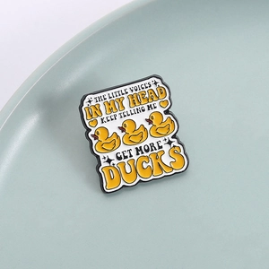 Funny enamel pin with three little yellow ducks and witty text on a blue background