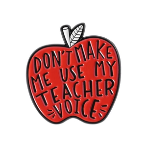 Red apple enamel teacher pin badge with text DON'T MAKE ME USE MY TEACHER VOICE