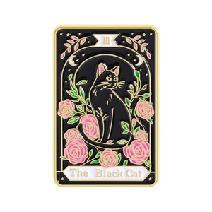 Tarot-style enamel brooch featuring a black cat and roses with gold metallic edges