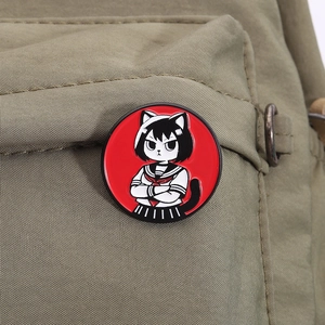 Detail of cartoon cat-ear girl enamel pin on olive green nylon bag strap