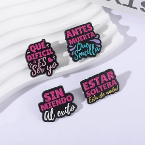 Set of 4 colorful Spanish motivational enamel pins with creative lettering on white background
