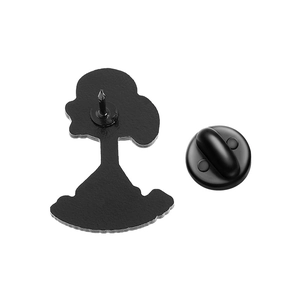 Detailed back view of a stick figure metal brooch with a black butterfly clutch pin