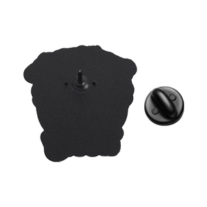 Macro shot of the black enamel pin backing with textured metal base and secure rubber clutch