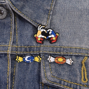 Three-piece set of celestial and crab heart enamel pins on a blue denim jacket