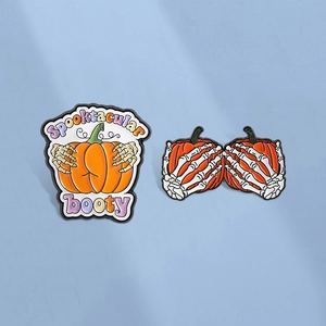 Halloween enamel pin set featuring pumpkin skeletons with funny SPOOKTACULAR text