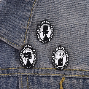 Gothic skull gentleman and cat silhouette enamel pin set on denim fabric