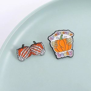 Creative Halloween enamel brooch set featuring pumpkin and skeleton hand with festive text