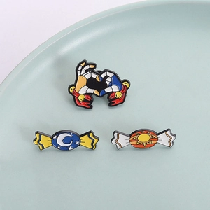 Enamel pins set featuring heart gesture hand, moon starry candy, and sun candy badges