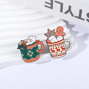 Christmas enamel pins featuring snowman and gingerbread man in festive coffee mugs