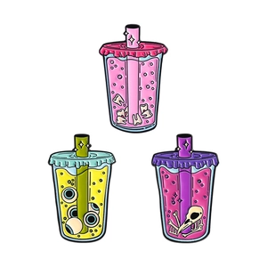 Creepy juice enamel pins with teeth eyeball and skull designs on colorful drink cups