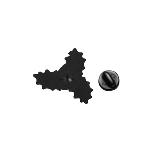 Detail of the black metal brooch backing with secure rubber clutch fastener on white